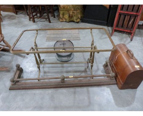 A brass coffee table frame; a brass fender; a sewing machine and parcel scales