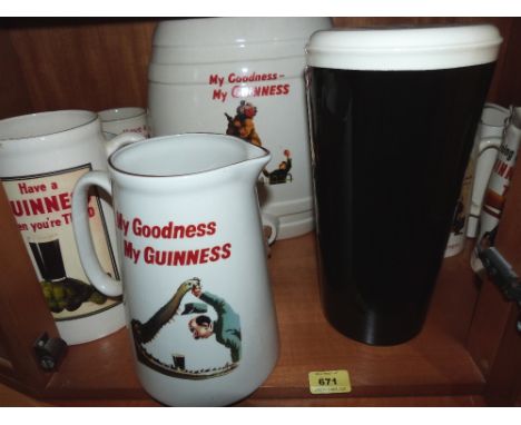 11 Guinness pub water jugs; a Guinness barrel and a ceramic pint of Guinness bar ornament
