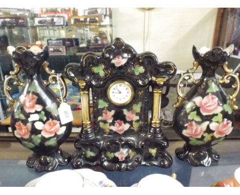 A Ceramic Clock Garniture, one Vase with Damage. 