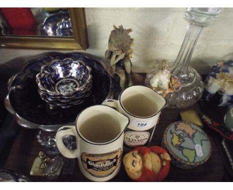 A Tray of Sundries to Include Thumb Cut Decanter, Advertising Water Jugs, Ceramic Figures, Glass Fruit Set Etc. 