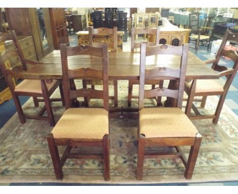 A Three Plank Refectory Table with Six Ladder Back Chairs.