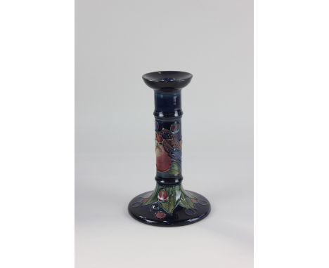 A Moorcroft pottery 'Finches Blue' candlestick, decorated with birds and fruit on blue ground, 20.5cm high, boxed