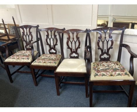 A set of four Chippendale style dining chairs including two carvers with pierced ribbon backs, drop in seats (three with tape