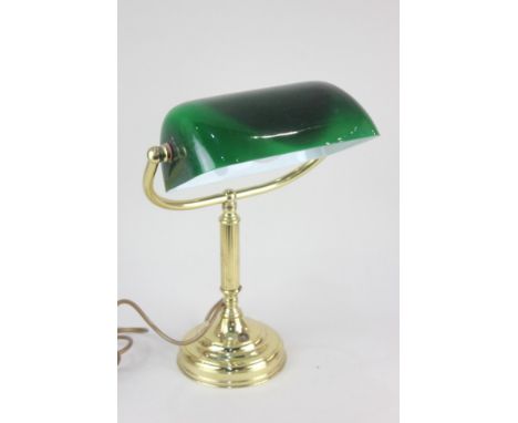 A brass desk lamp with green glass shade, 37cm high