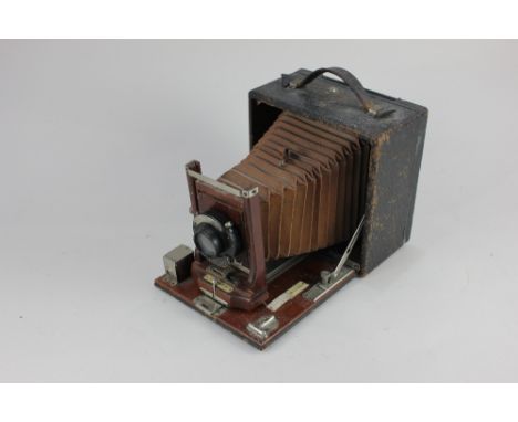 A Conley American mahogany and leather clad half plate camera (a/f)