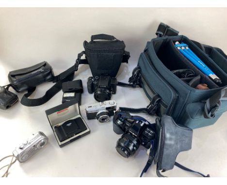 A Minolta 7000 camera, together with three lenses, flash, small blue tripod and other accessories, in camera bag, together wi