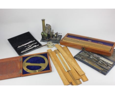 A model tabletop steam engine, base 14cm, three cased sets of measuring and drawing instruments, and a collection of wooden r