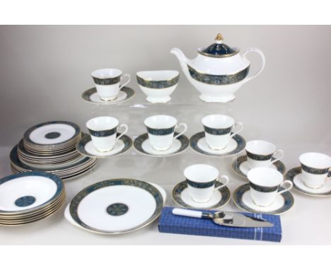A Royal Doulton 'Carlyle' part tea and dinner service, decorated with blue floral bands and gilt embellishments, comprising t