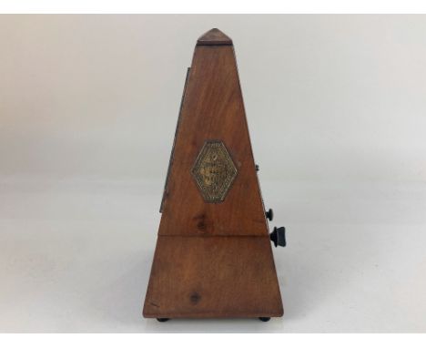 A 19th century mahogany cased metronome, the embossed brass plaque stating 'Metronome Maelzel, France, Paris' 23cm high (a/f)