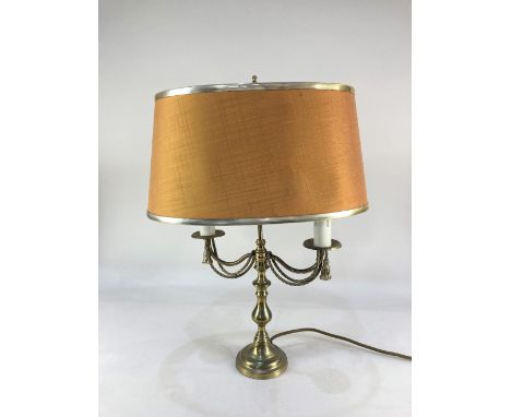 A brass two branch table lamp, with swagged decoration and amber shade, 54cm high