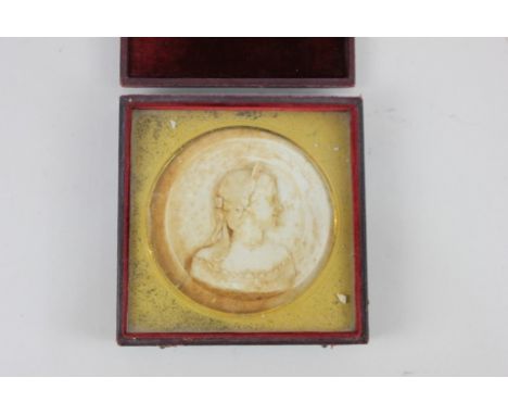 A 19th century circular cast portrait profile of a lady, in fitted case, 10cm diameter (a/f)