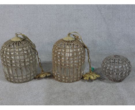 A pair of contemporary gilt metal and glass dome shaped hanging light fittings, together with a spherical shaped glass hangin