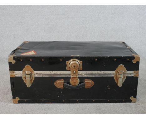 A 20th century black painted metal travelling case/trunk, with studded detail, opening to reveal   lined interior. H.30 W.76 