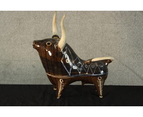 A mid 20th century glazed and painted ceramic modernist bull, signed and dated '56 to base. H.35 W.35 D.19cm. 