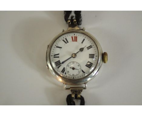 An Art Deco silver watch with white enamel dial with Roman numerals and stop watch dial. Hallmarked: GS, London import mark, 