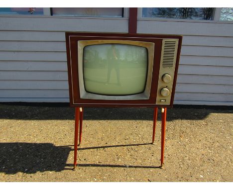 A vintage Philips television raised on round tapering legs