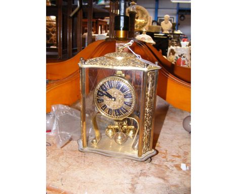 A decorative gilt cased mantel clock 