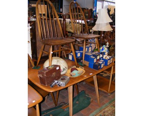 A vintage mid century Ercol drop leaf rectangular dining table, together with four Ercol 'Quaker' dining chairs 