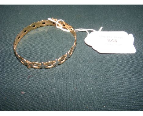 A yellow metal bangle