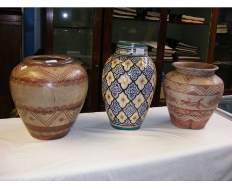 Two vintage decorated terracotta vases together with a Continental glazed baluster vase