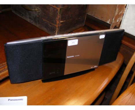 A Panasonic SC-HC30DB Compact Stereo System with operating instructions and remote 