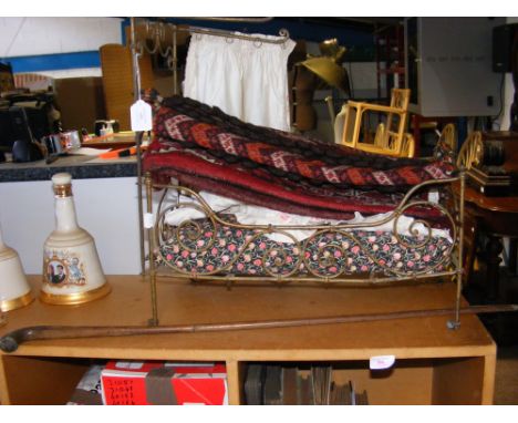 A wire metal framed doll's bed, a woven saddlebag and an old walking stick 