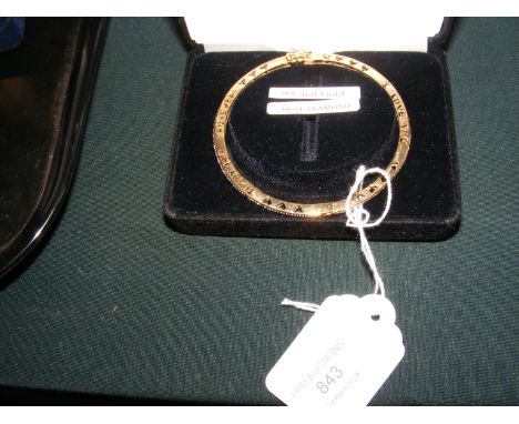 A 9ct gold and diamond bangle in presentation case