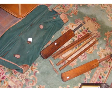 A vintage Eaton stamped cricket bat, together with wickets and other cricket items - in canvas bag 