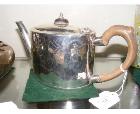 A silver teapot with engraved decoration