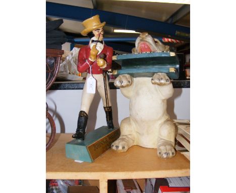 A Johnnie Walker Scotch Whisky advertising stand, together with newspaper dog statue 
