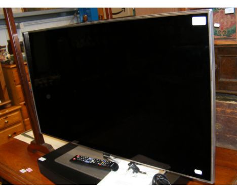 A Samsung UE40F7000STXXU 40inch screen TV with User Manual and remote 