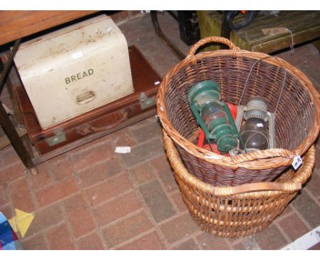 A vintage bread bin, suitcase, two wicker baskets, hurricane lamps etc.