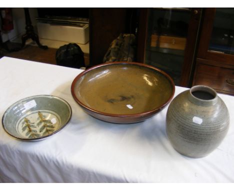 A Poole Pottery ribbed vase, together with two studio pottery bowls