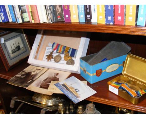 A 1914/15 Star medal, British War medal, Victory medal and Naval Long Service and Good Conduct medal - in frame, together wit