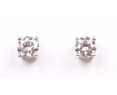 A pair of diamond ear studsThe round brilliant cut diamonds, in a four claw setting, to ear post and butterfly backs, stamped