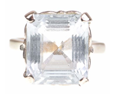 An aquamarine ringThe step cut aquamarine, claw set to a precious rose metal shank stamped 9ct, ring size N 1/2   CONDITION R
