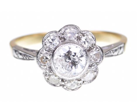 A diamond cluster ringCentring a round brilliant cut diamond, to a single cut diamond surround, to tapered shoulders, princip