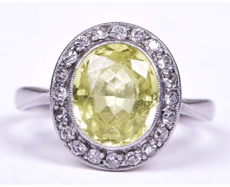 A peridot and diamond cluster ringThe oval shaped peridot to a single-cut diamond surround, ring size K 1/2   CONDITION REPOR