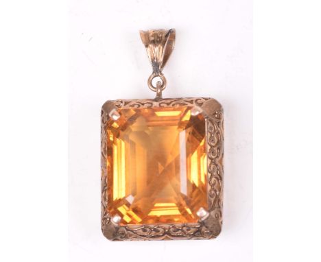 A citrine pendantThe rectangular step cut citrine, set to a scroll work precious yellow metal border marked 14c, length 3.7cm