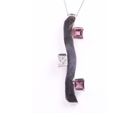 A pink sapphire and diamond pendantThe wavy 18k white gold pendant, set with two step cut pink sapphires and a rectangular sh