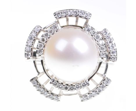 A cultured pearl and diamond dress ringThe large white pearl within a graduated round brilliant cut diamond surround, to prec