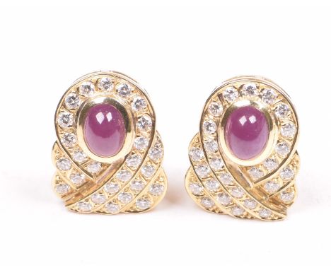 A pair of ruby and diamond set earringsThe oval cabochon cut rubies, to a round brilliant cut diamond three row stepped clust