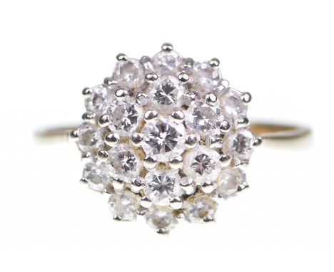 A diamond cluster ringThe round brilliant cut diamond to a round brilliant cut stepped diamond surround, total diamond weight