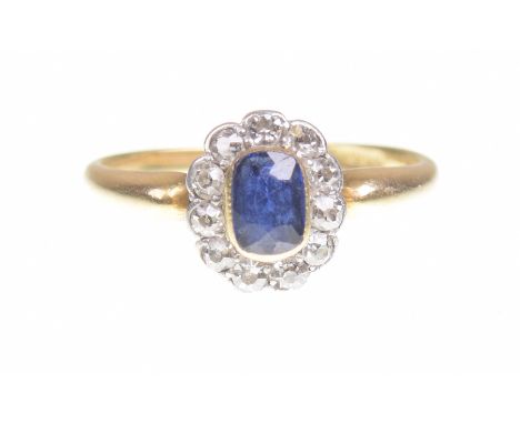 A sapphire and diamond cluster ringThe cushion shaped sapphire to an old-cut diamond surround, the shank stamped 18ct, total 