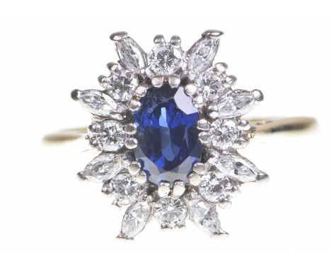 A sapphire and diamond cluster ringThe oval shaped sapphire to an alternating round brilliant cut and marquise shaped diamond
