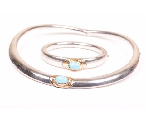 A turquoise, silver and gold torque and bangle suiteThe turquoise oval cabochon, to a gold bezel setting, centrally set to a 