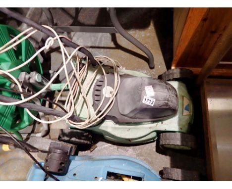Electric lawnmower with hose lock hose pipe on stool. All electrical items in this lot have been PAT tested for safety and ha