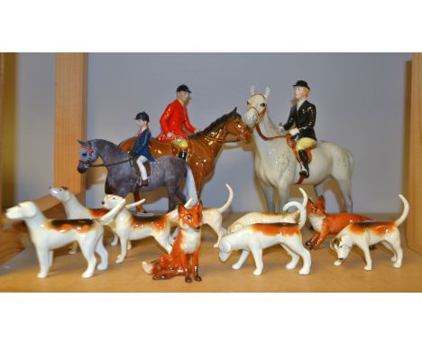 A Beswick hunting set comprising of huntsman, huntswoman, hounds and foxes (11)