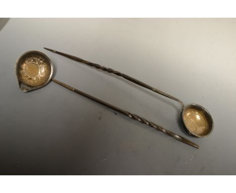 A George II white petal toddy ladle; inset coin, whale bone handle another similar (2)