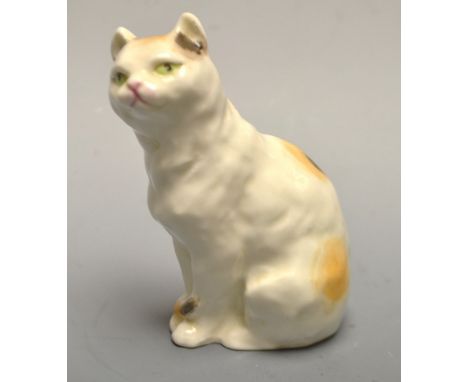 A Royal Worcester seated cat, modelled by FG Doughty, handpainted, green eyes, 9cm, printed mark in black